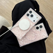 Two phone cases with opal shell pattern held by a person wearing a black hijab.