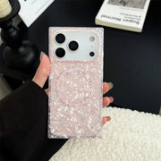 Phone case with opal shell design and magsafe held by a person, with a blurred background