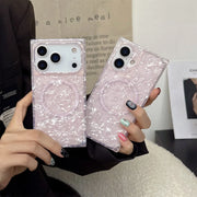 Person holding two pink opal shell phone cases with glittery texture