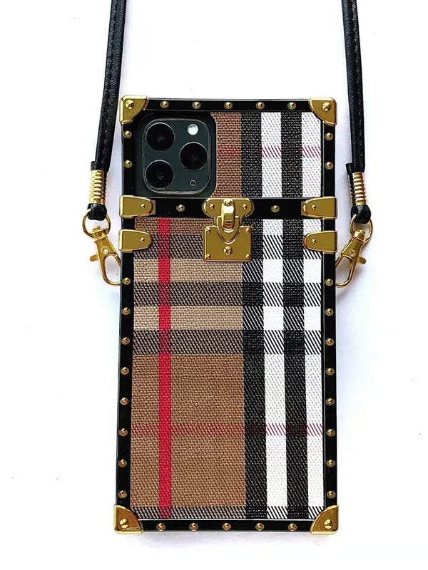 Plaid-patterned phone case with gold accents and strap on a white background