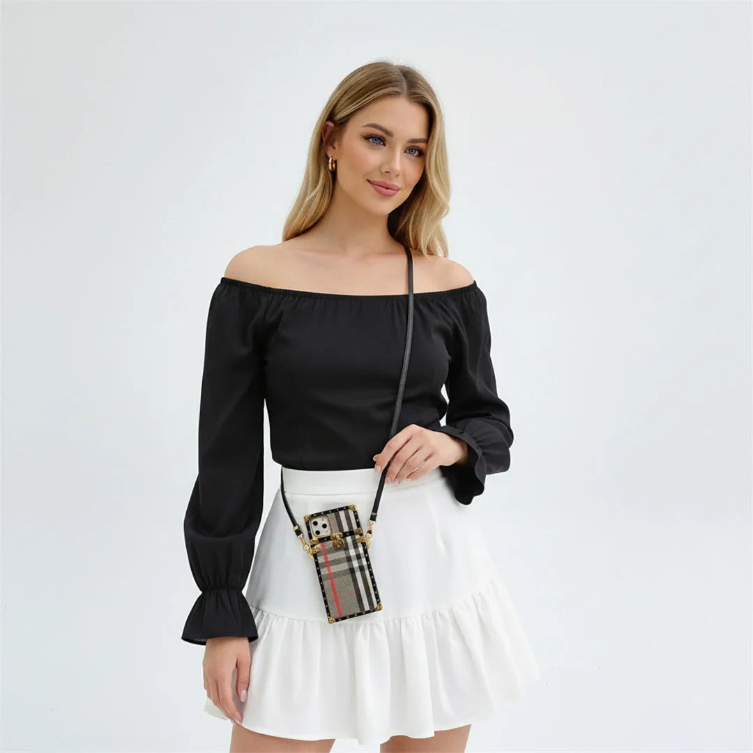 Woman wearing a black off-shoulder top and white skirt with a plaid handbag on a light gray background