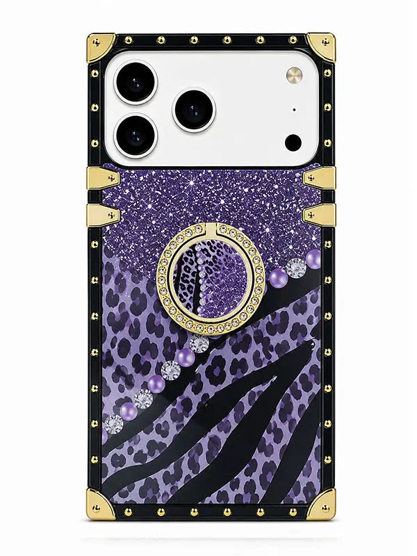 A protective phone case with a purple leopard print and zebra stripe pattern, featuring a central circular mirror, purple rhinestones, and a black border with gold-tone metal studs and corner protectors.