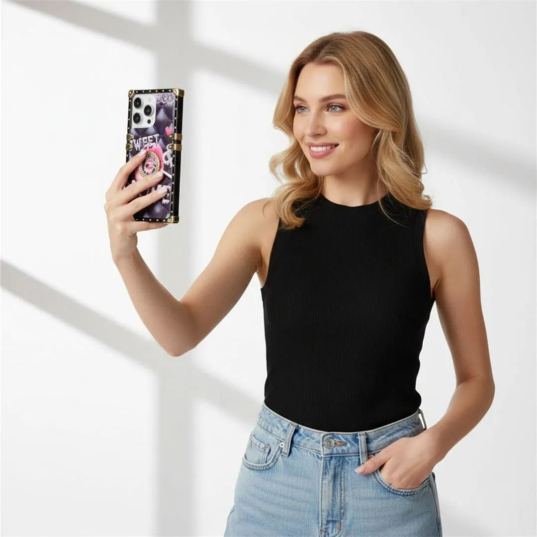 Woman holding a phone with a colorful case against a white background