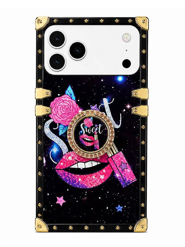 A protective phone case with a black galaxy background, decorated with a pink rose, glittery lips, a magnifying glass with the word 'Sweet', and a pink lipstick tube, framed by gold-tone rivets and corner protectors.