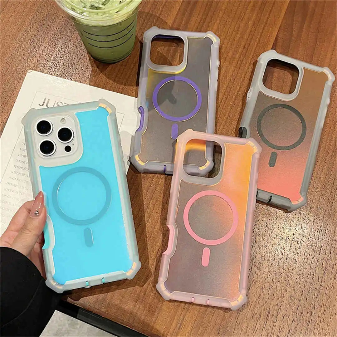 Four phone cases with different color schemes on a wooden surface.