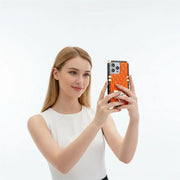 Woman holding a smartphone with a distinctive design on a white background