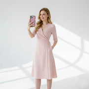 Woman in a pink dress taking a selfie with iPhone 17 Pro in pink case