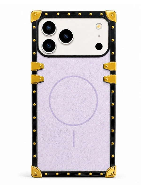 A protective phone case with a black border, gold corner protectors and rivets, and a light purple textured center panel featuring a faint MagSafe ring.