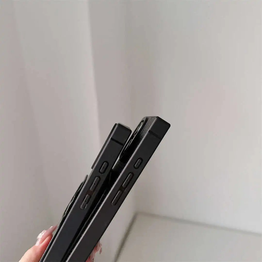 Side view of two black Noir Card Square iPhone cases showing square edges and button cutouts