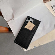 Black Noir Card Square iPhone wallet case on a chair with a card in its rear slot