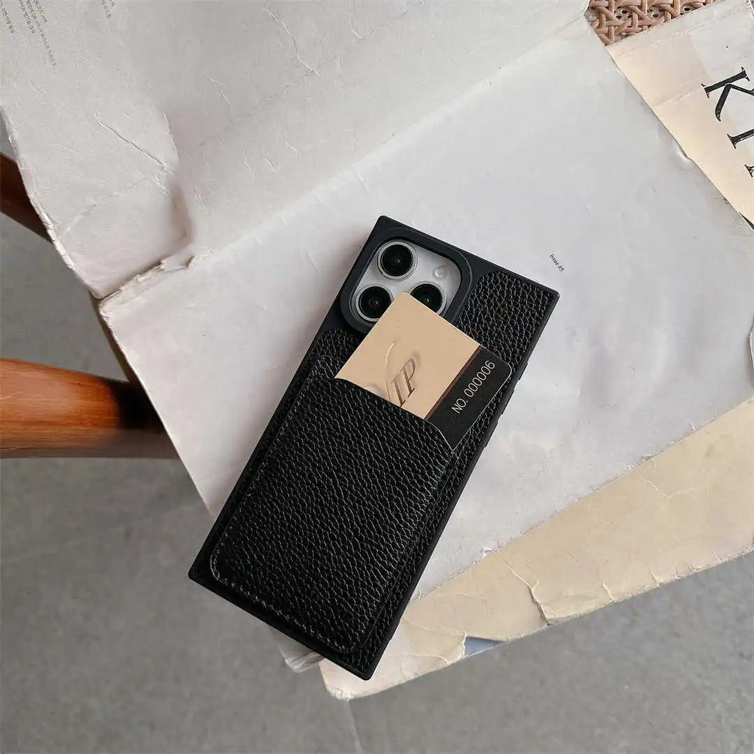 Black Noir Card Square iPhone wallet case on a chair with a card in its rear slot