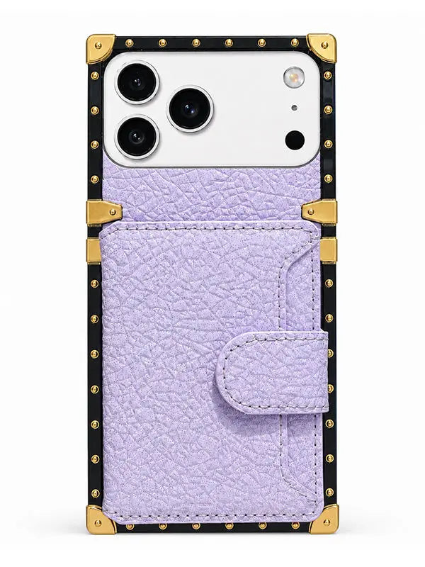 A light purple textured leather wallet phone case with gold-tone metal corner guards and a black studded border, shown on a white phone against a plain white background.