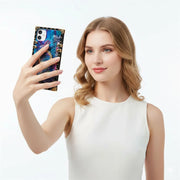 Woman holding a smartphone with a colorful case against a white background