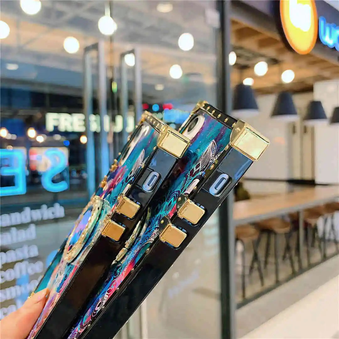 Phone case with decorative elements held in front of a store window