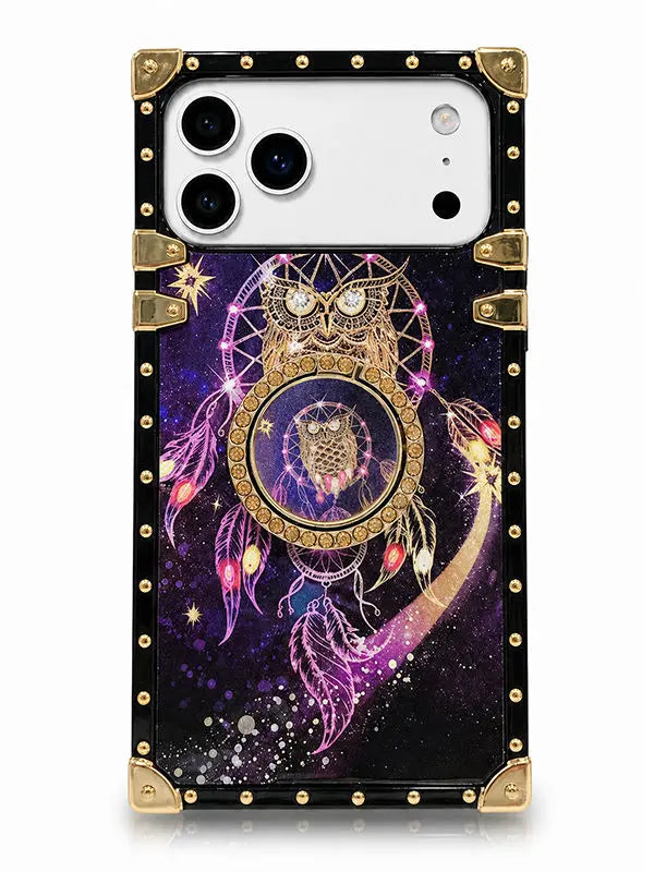 A protective phone case with a fantasy design, featuring a dreamcatcher and owl motif over a purple and black galaxy background, finished with gold-tone metal corner guards and rivets.