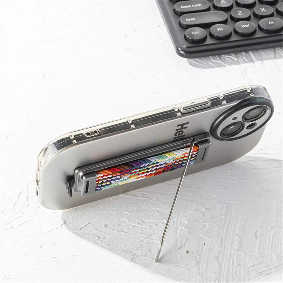 Phone with a stick-on strap stand on a light surface