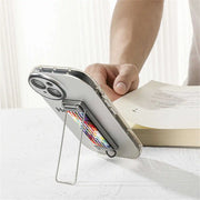 Phone case with a strap stand held by a hand on a white surface