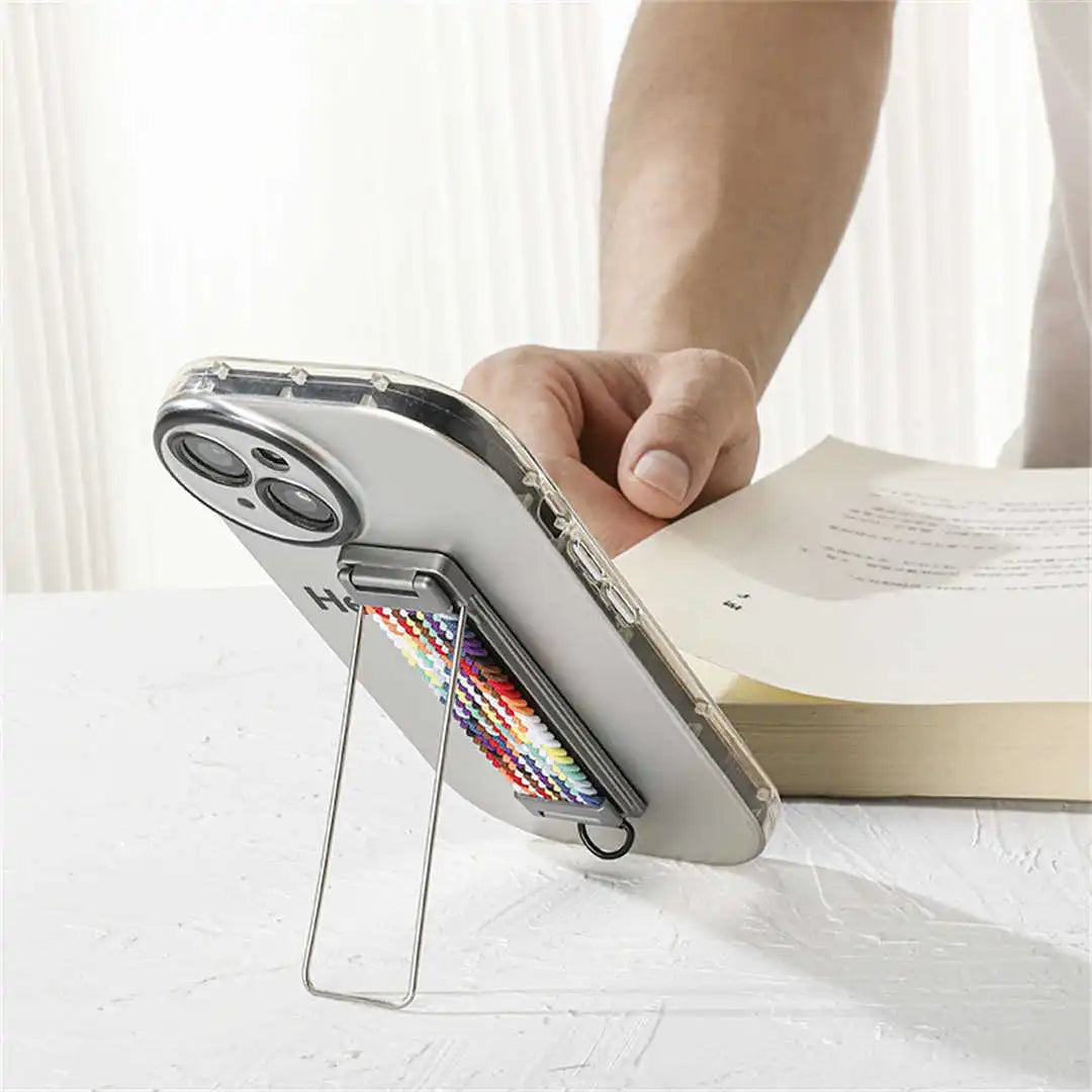 Phone case with a strap stand held by a hand on a white surface