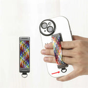 Colorful phone grip with a hand holding a smartphone on a white background