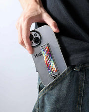 Person holding a phone with a colorful finger loop on back