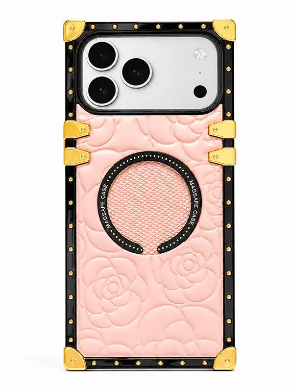 A luxury-style phone case with a pink quilted rose pattern, black trim, gold corner protectors, and a circular magnetic ring, shown on a white background.