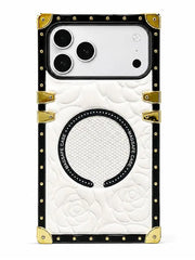 A luxury-style phone case featuring a white quilted rose pattern, a black horseshoe-shaped magnetic ring, and gold-tone metal corner protectors and rivets, shown on a white background.