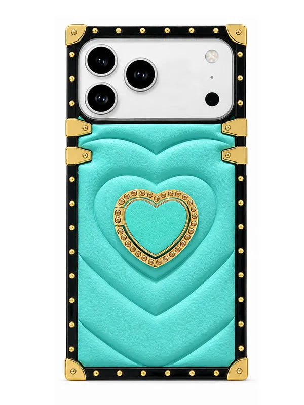 A turquoise and black phone case with gold accents, featuring a quilted chevron pattern, a central heart design with rhinestone trim, and gold-tone corner protectors, shown on a white background.