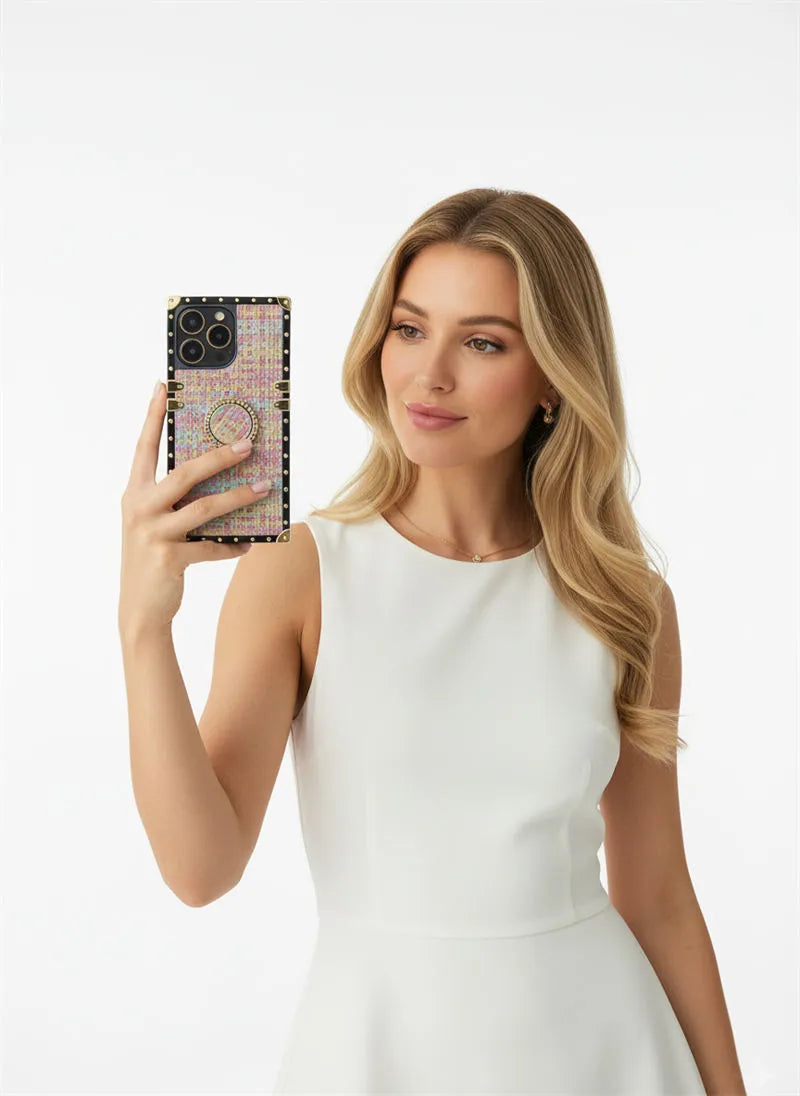 Woman in a white dress holding a phone with a decorative case against a white background
