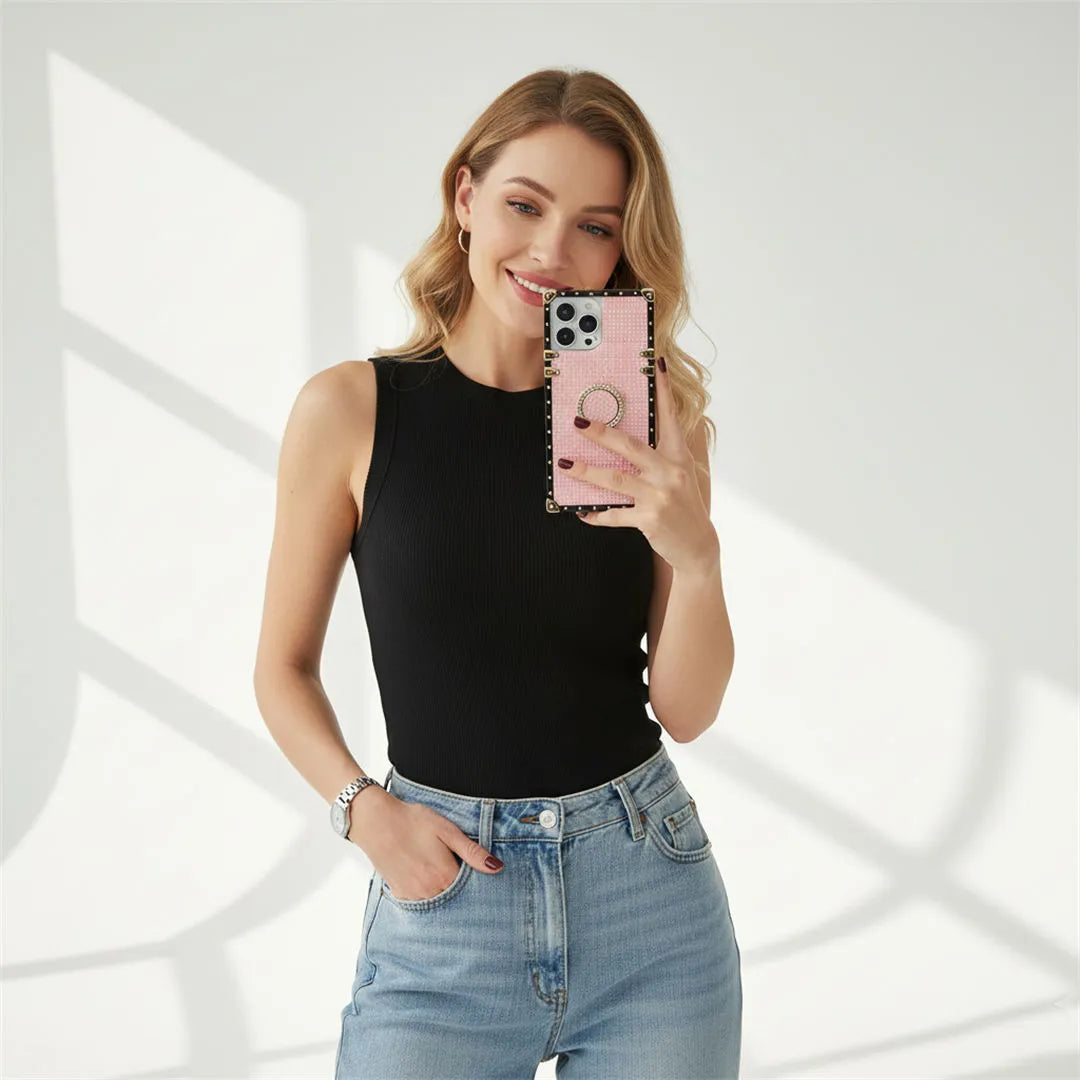 Woman holding a phone with a pink case against a white background