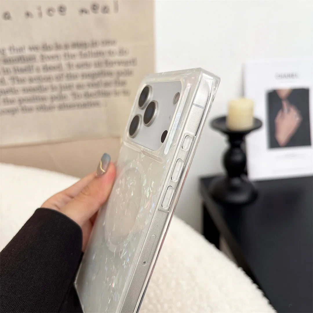 Person holding a phone with a magsafe case in a cozy indoor setting