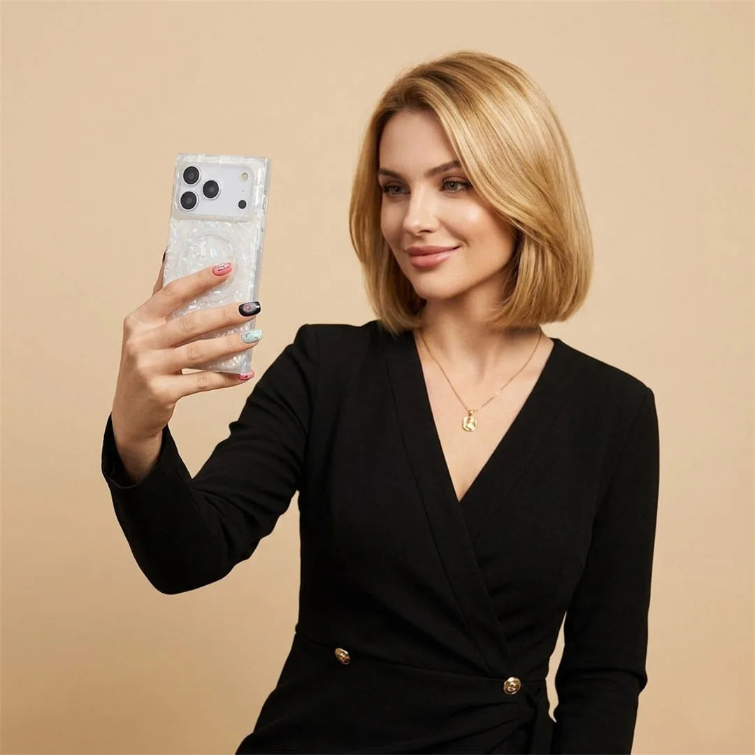 Woman in a black outfit holding a phone in opal shell case with a beige background