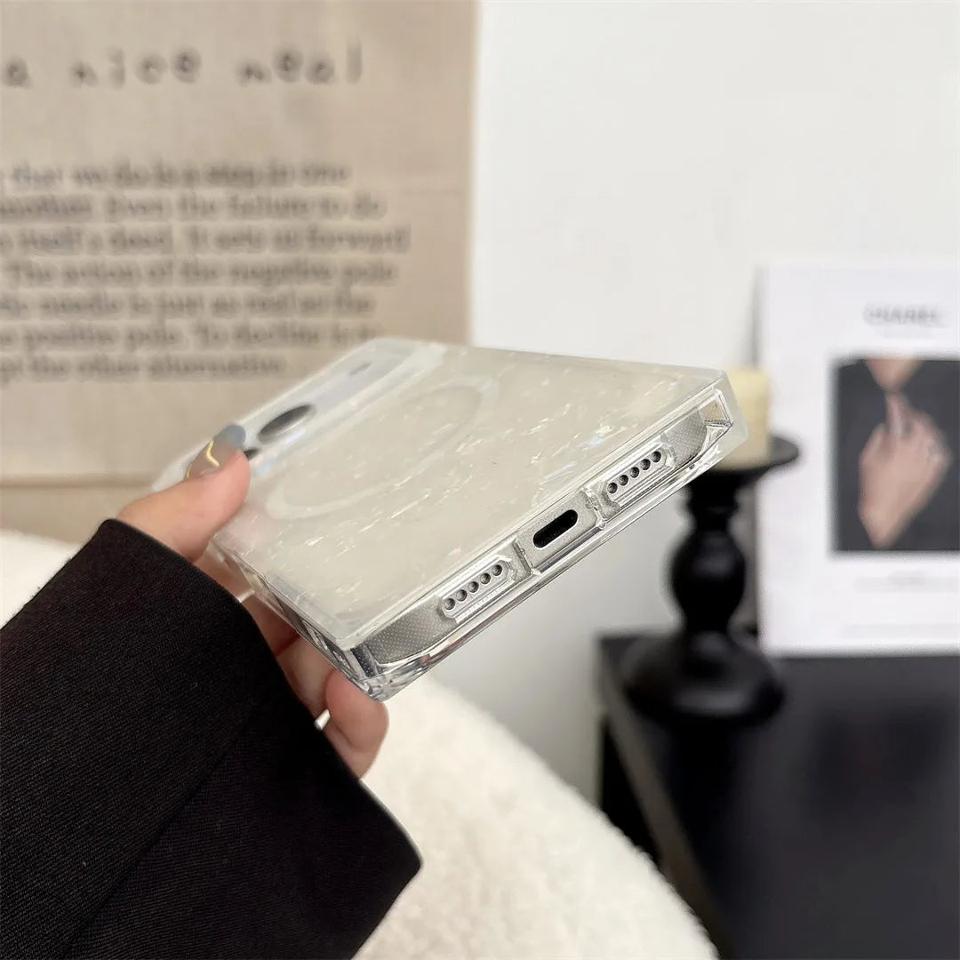 opal shell phone case held by a hand with a blurred background